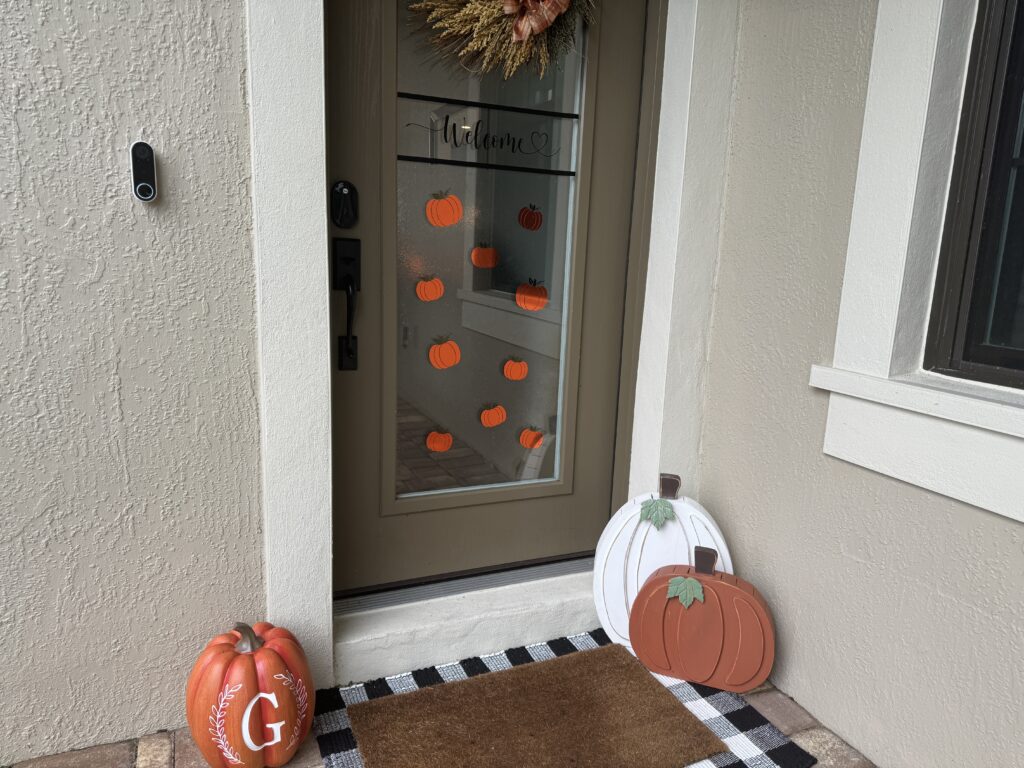 Our pumpkin decals applied to our front door glass.